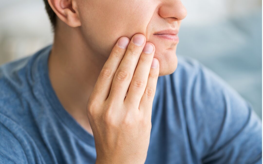 A close-up of a person touching his jaw, Practical Solutions for Tooth Sensitivity from Modern Care Endodontics