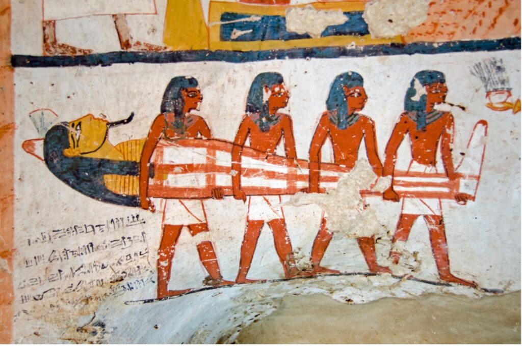 An ancient Egyptian drawing of three people carrying a sarcophagus, Ancient Remedies: Early Attempts at Dental Care