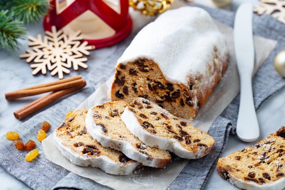 A sliced fruit cake with a white glaze on top
