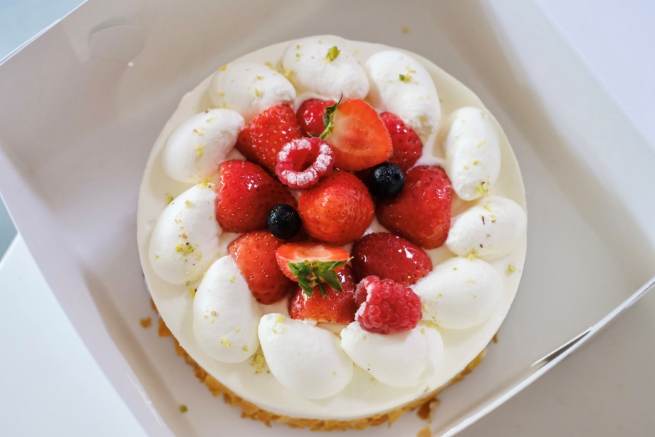 A cake with strawberries and cream on top