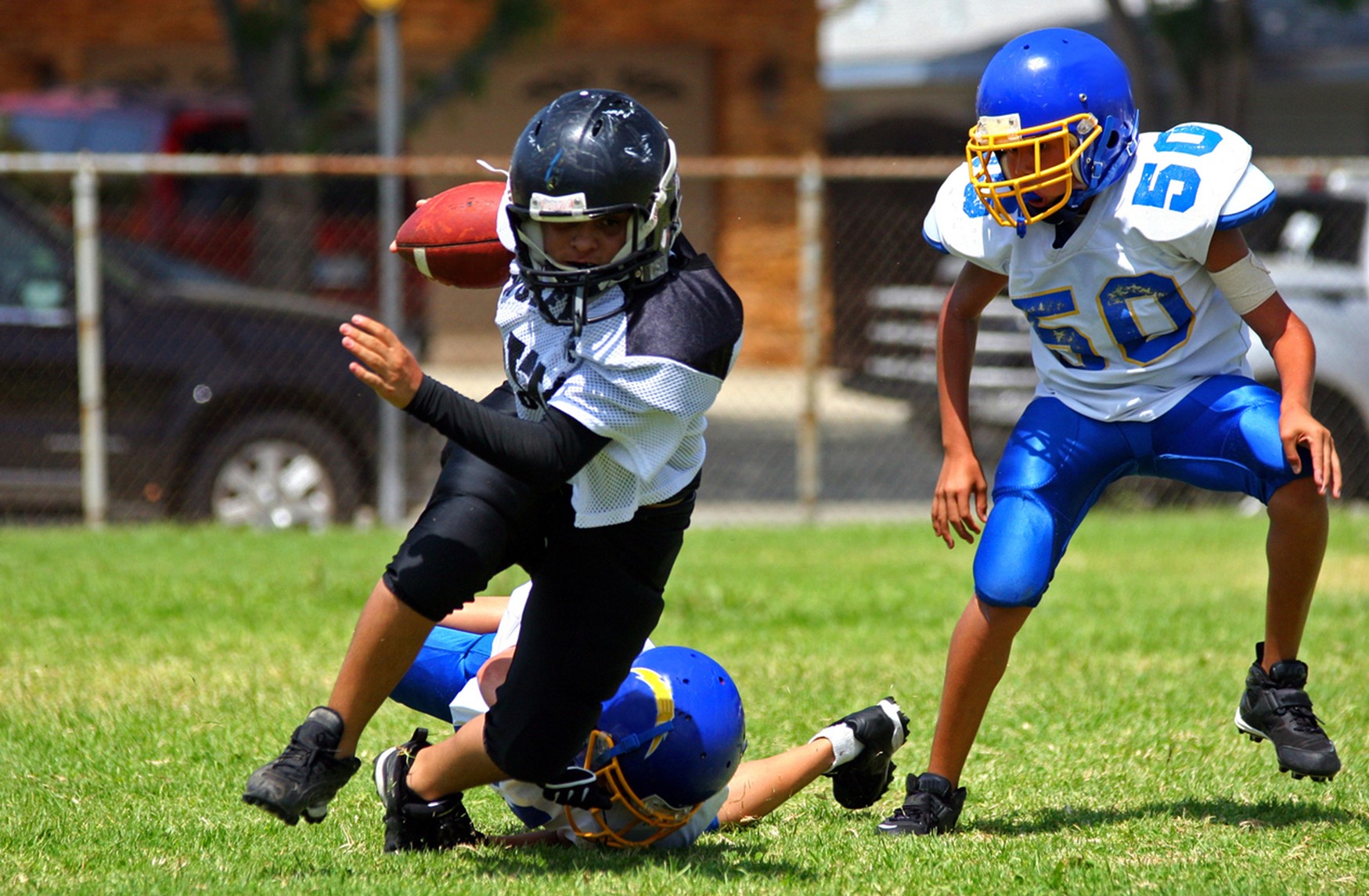 A group of people playing football, Children’s Tooth Pain